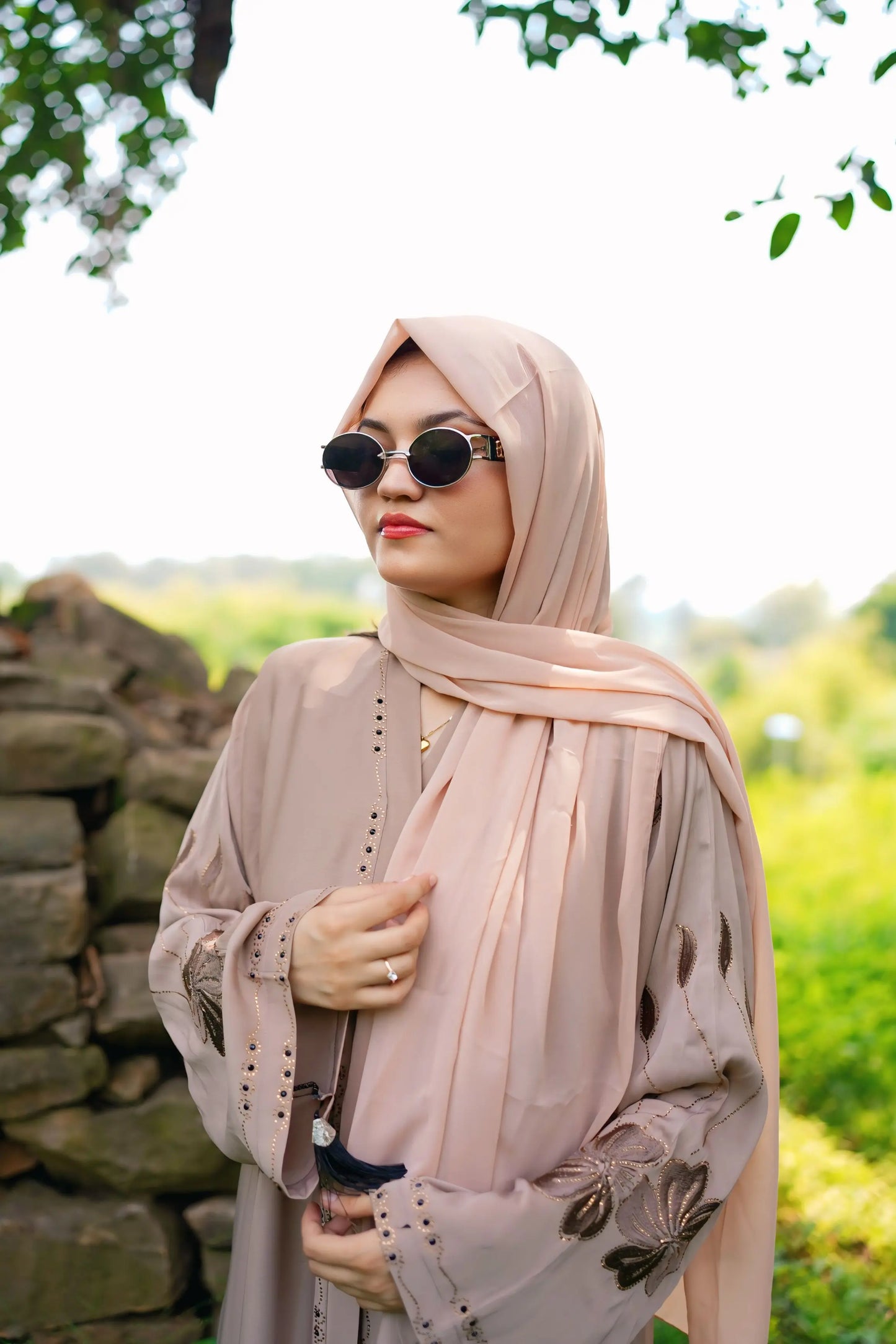 Girl in a modest abaya dress paired with a classic hijab for a timeless look.