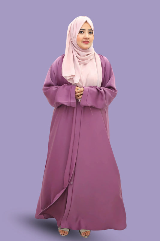 Young woman styled in an abaya and hijab representing Islamic modest fashion.