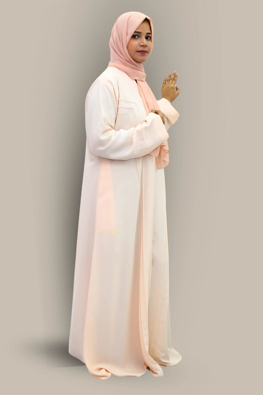 Young woman styled in an abaya and hijab representing Islamic modest fashion.