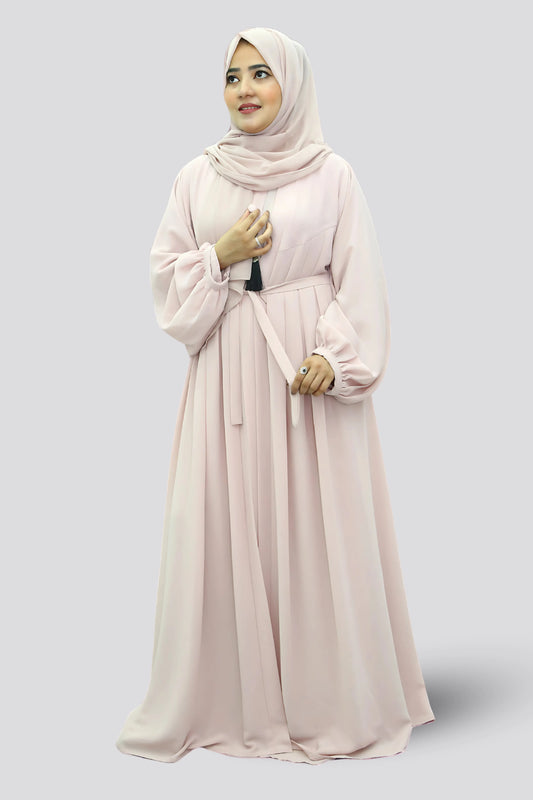 Elegant young woman wearing a black abaya and hijab, showcasing modest fashion style.