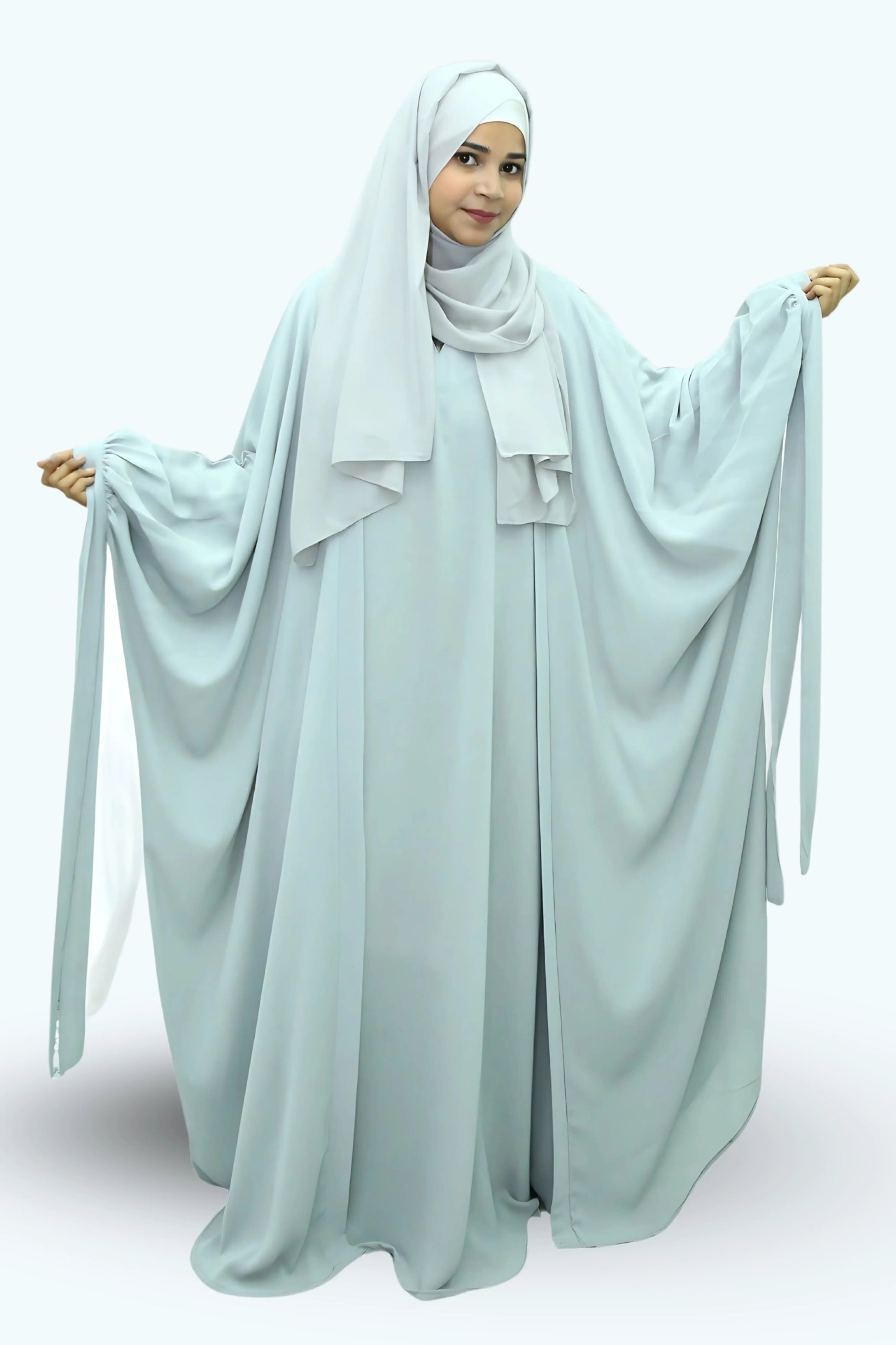 Modern Muslim girl in premium abaya and matching hijab standing with confidence.