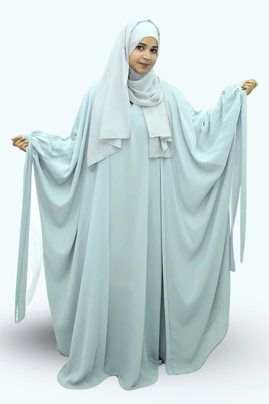 Modern Muslim girl in premium abaya and matching hijab standing with confidence.