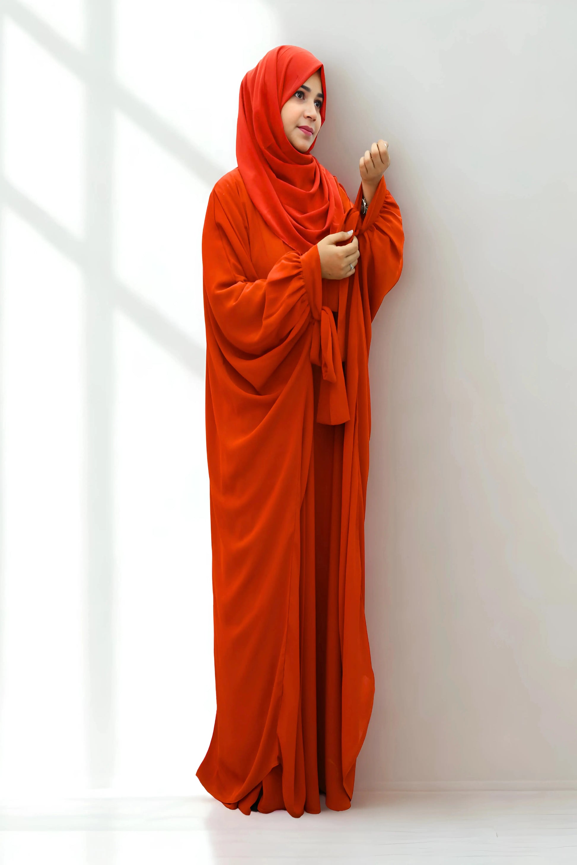 Girl in a modest abaya dress paired with a classic hijab for a timeless look.