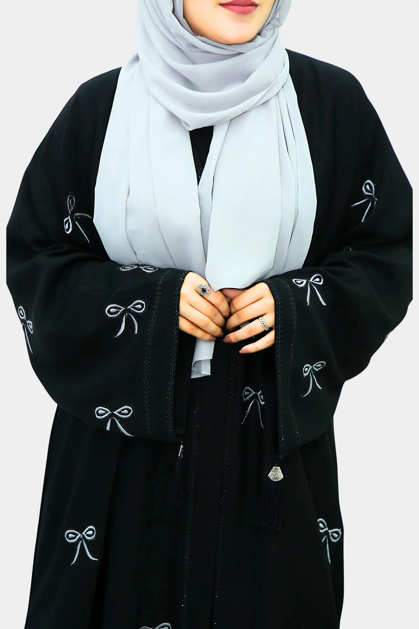 Muslim woman wearing a graceful abaya with a neatly draped hijab.