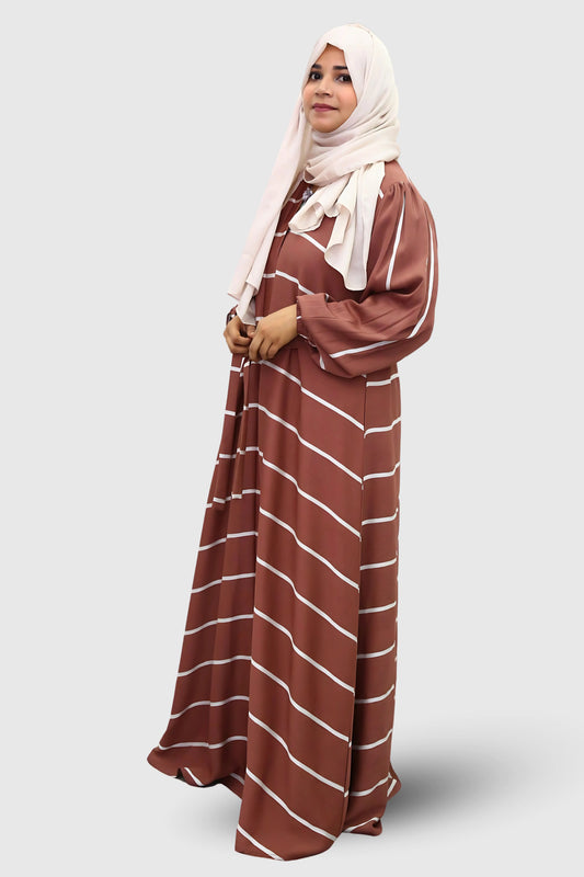 Modern Muslim girl in premium abaya and matching hijab standing with confidence.