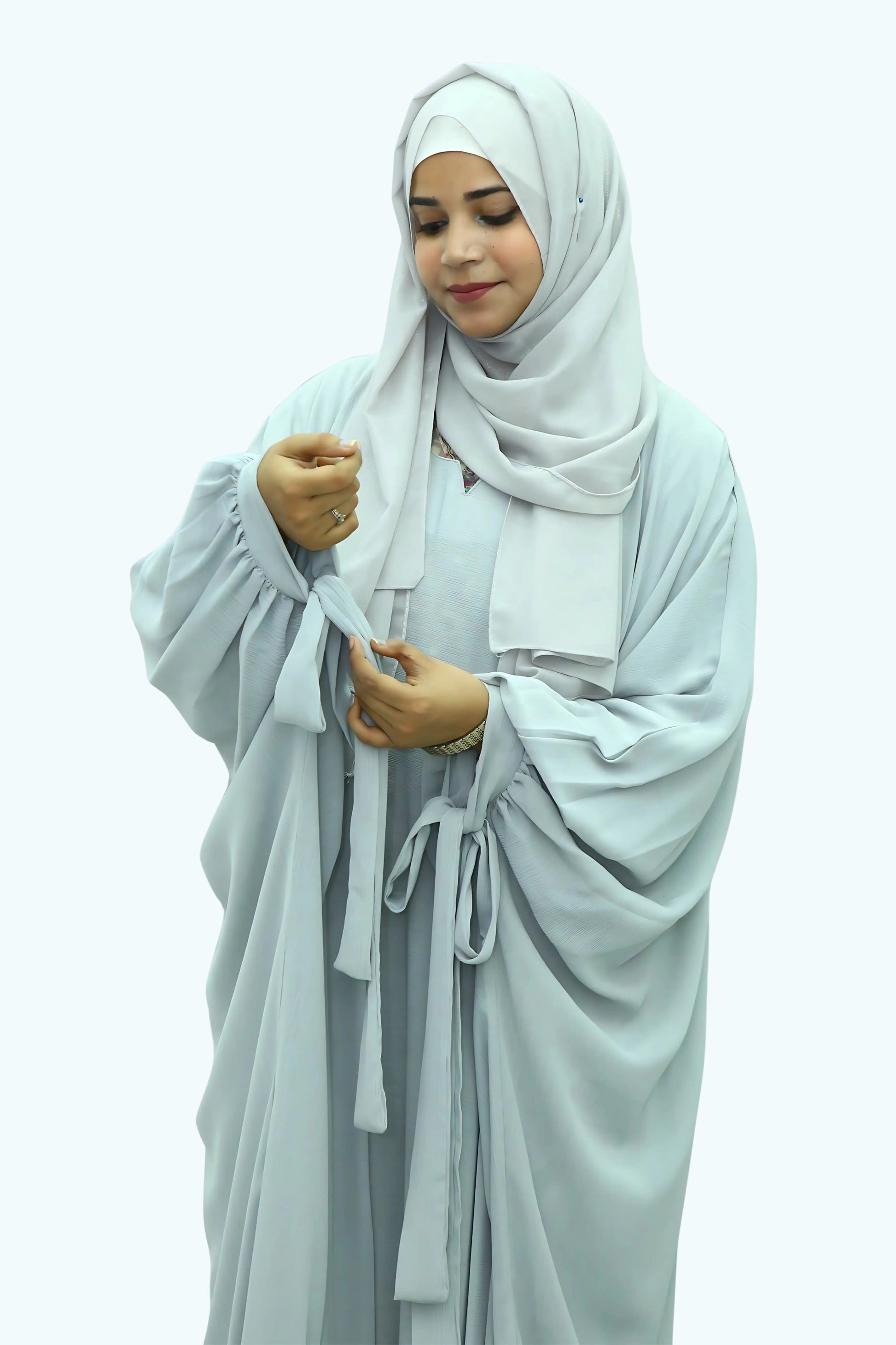 Modern Muslim girl in premium abaya and matching hijab standing with confidence.