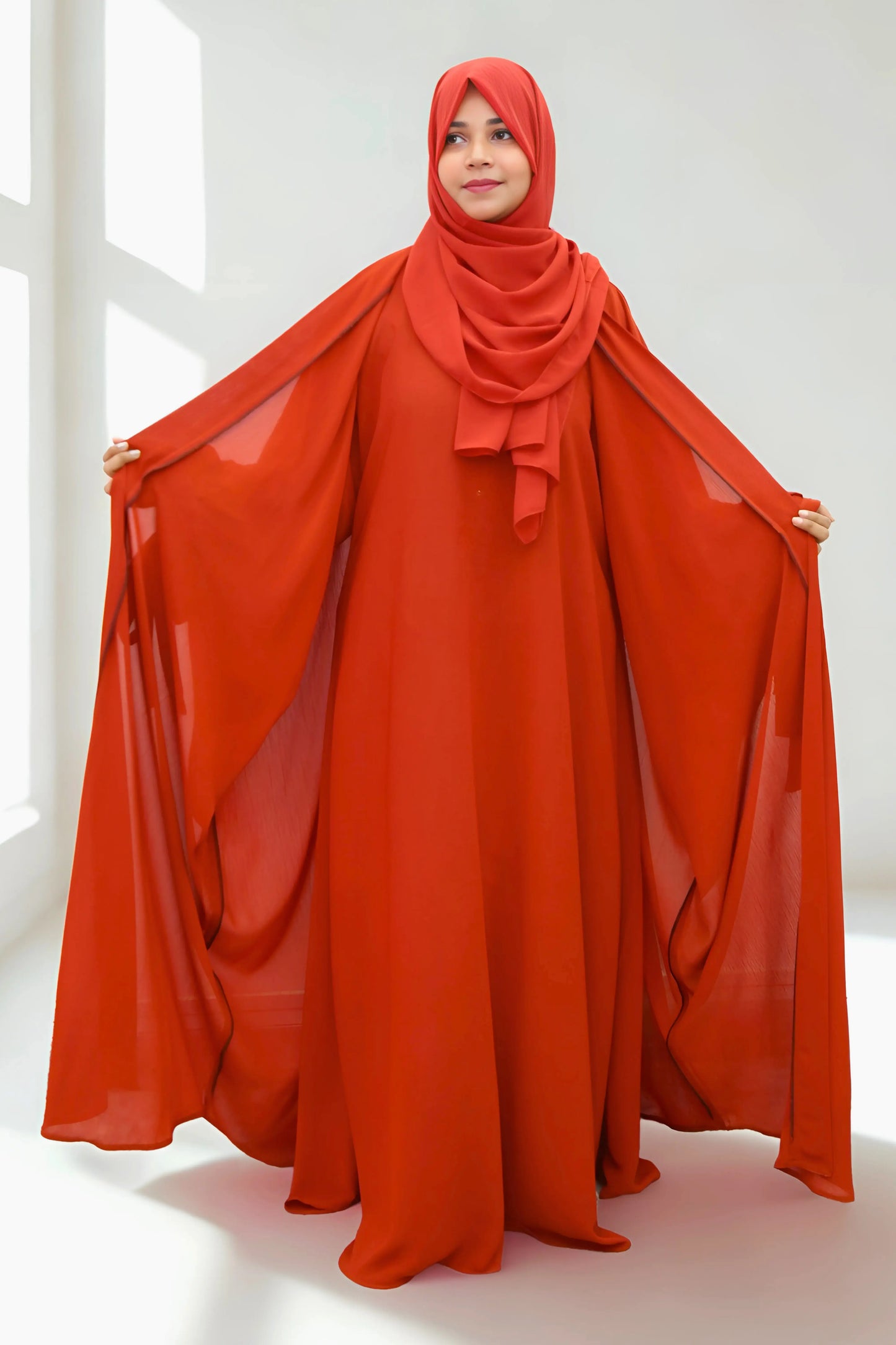 Girl in a modest abaya dress paired with a classic hijab for a timeless look.