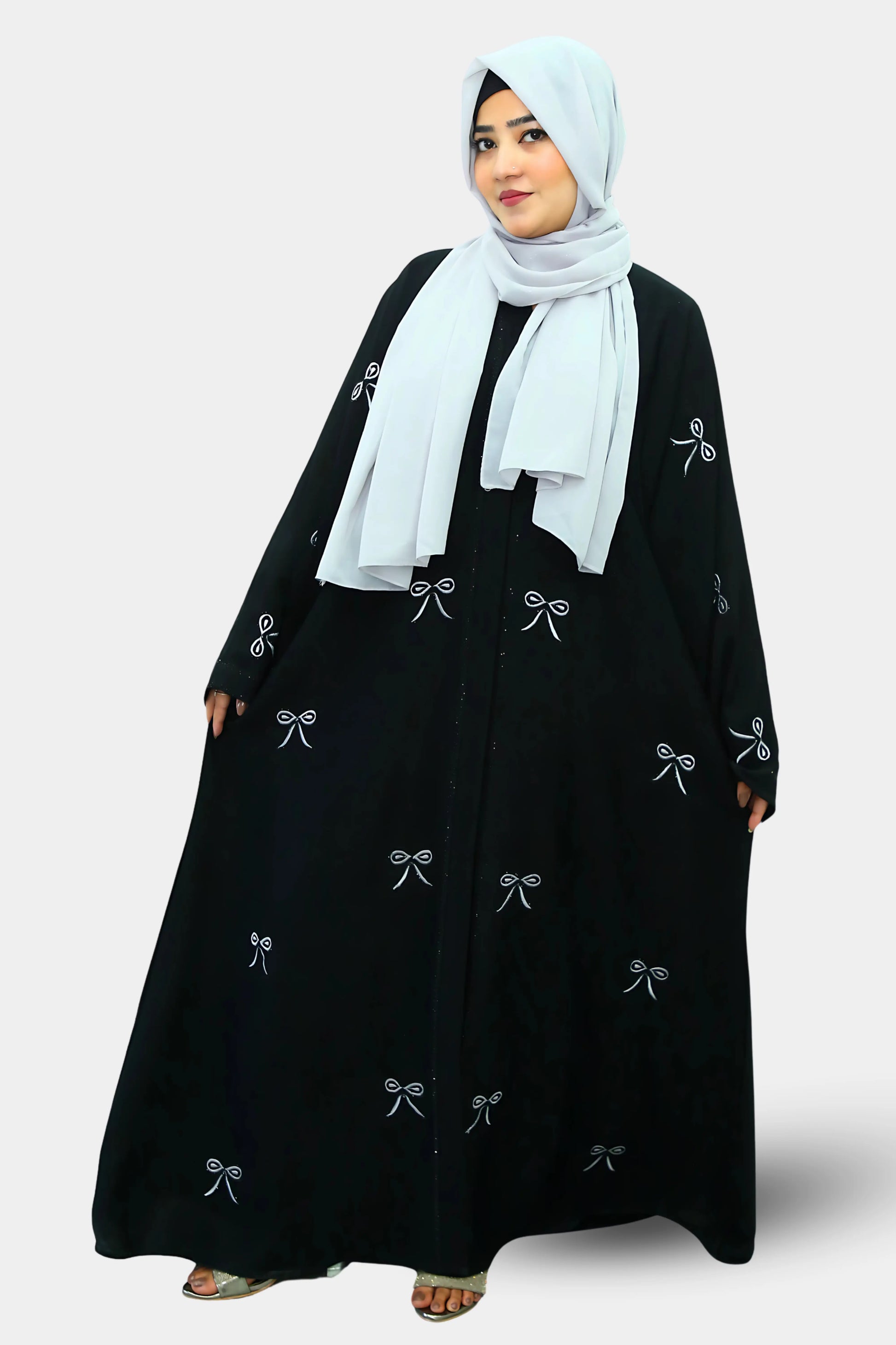 Muslim woman wearing a graceful abaya with a neatly draped hijab.