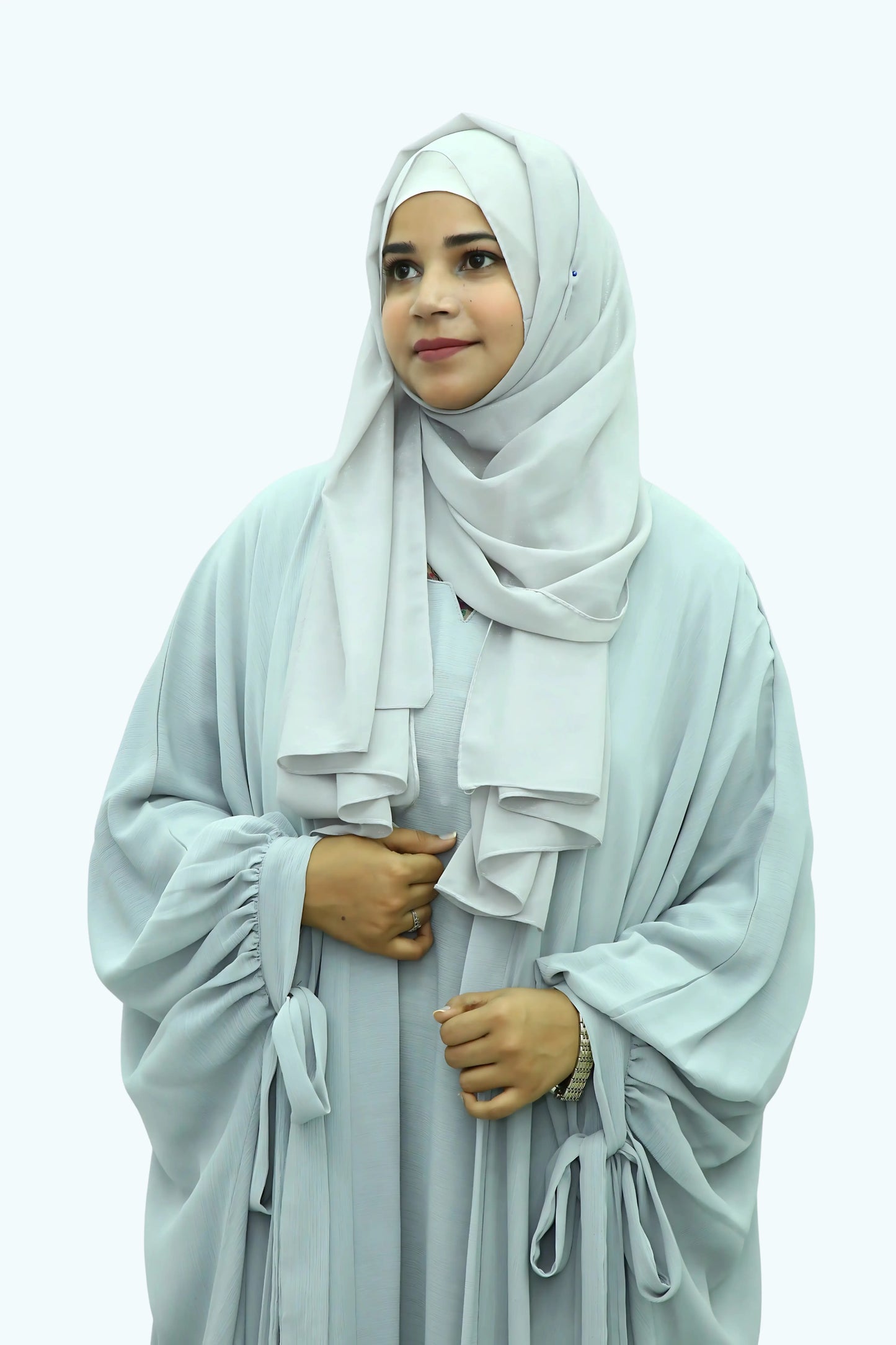 Modern Muslim girl in premium abaya and matching hijab standing with confidence.
