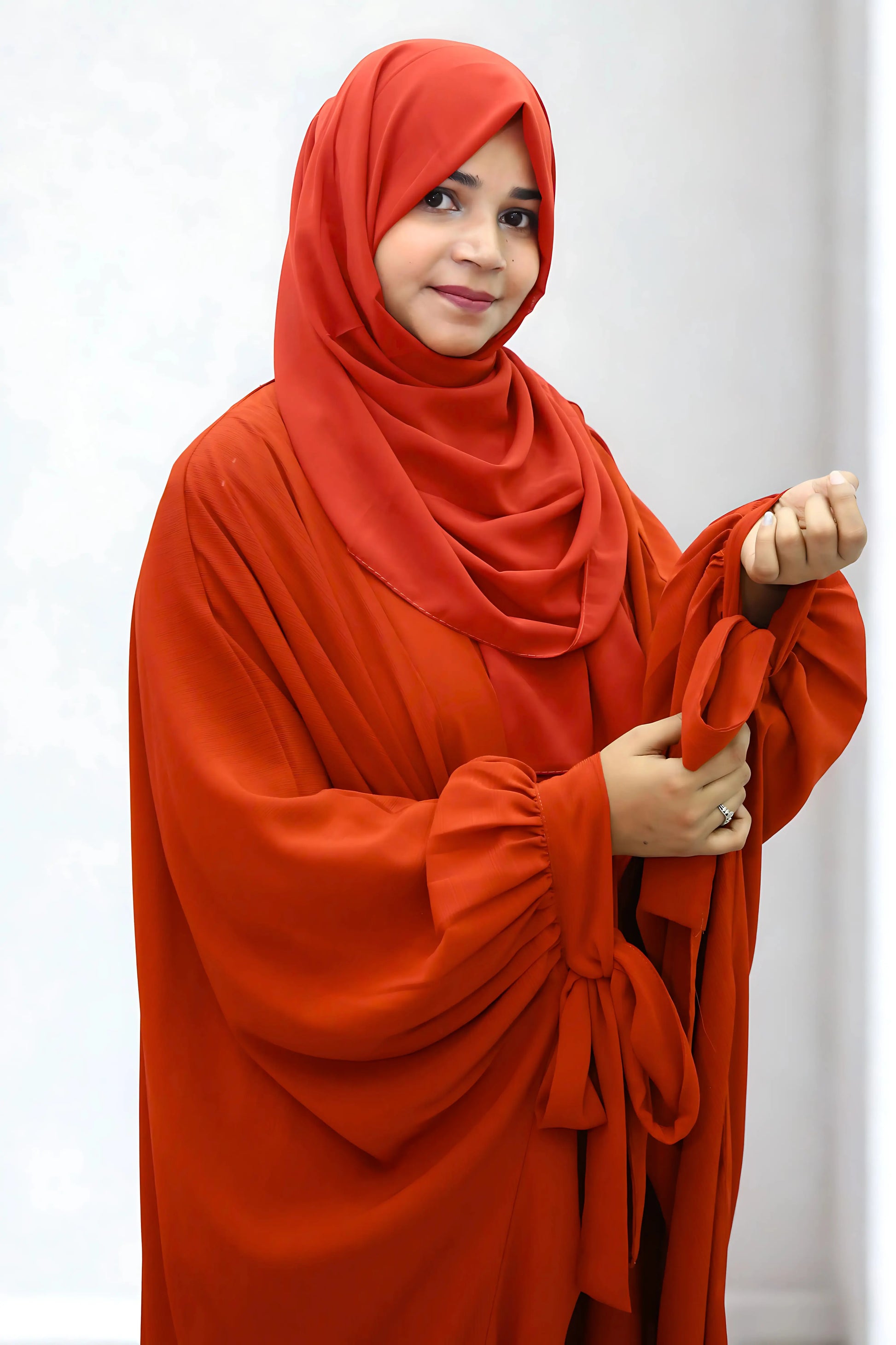 Girl in a modest abaya dress paired with a classic hijab for a timeless look.