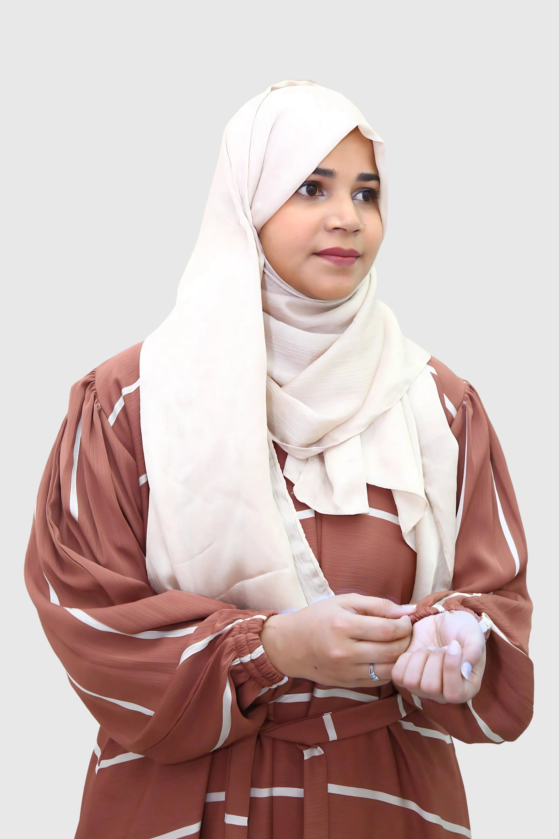 Modern Muslim girl in premium abaya and matching hijab standing with confidence.