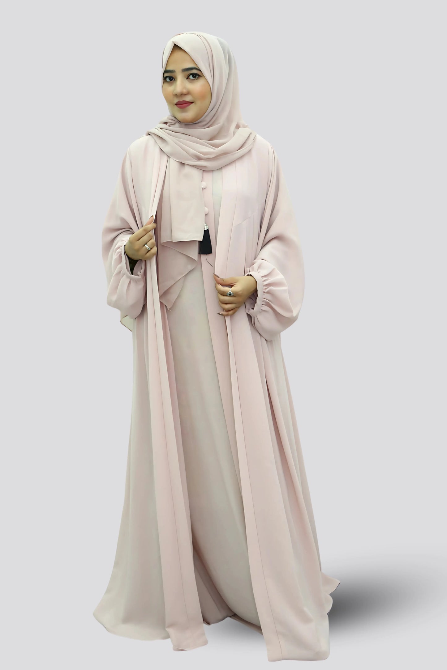 Elegant young woman wearing a black abaya and hijab, showcasing modest fashion style.