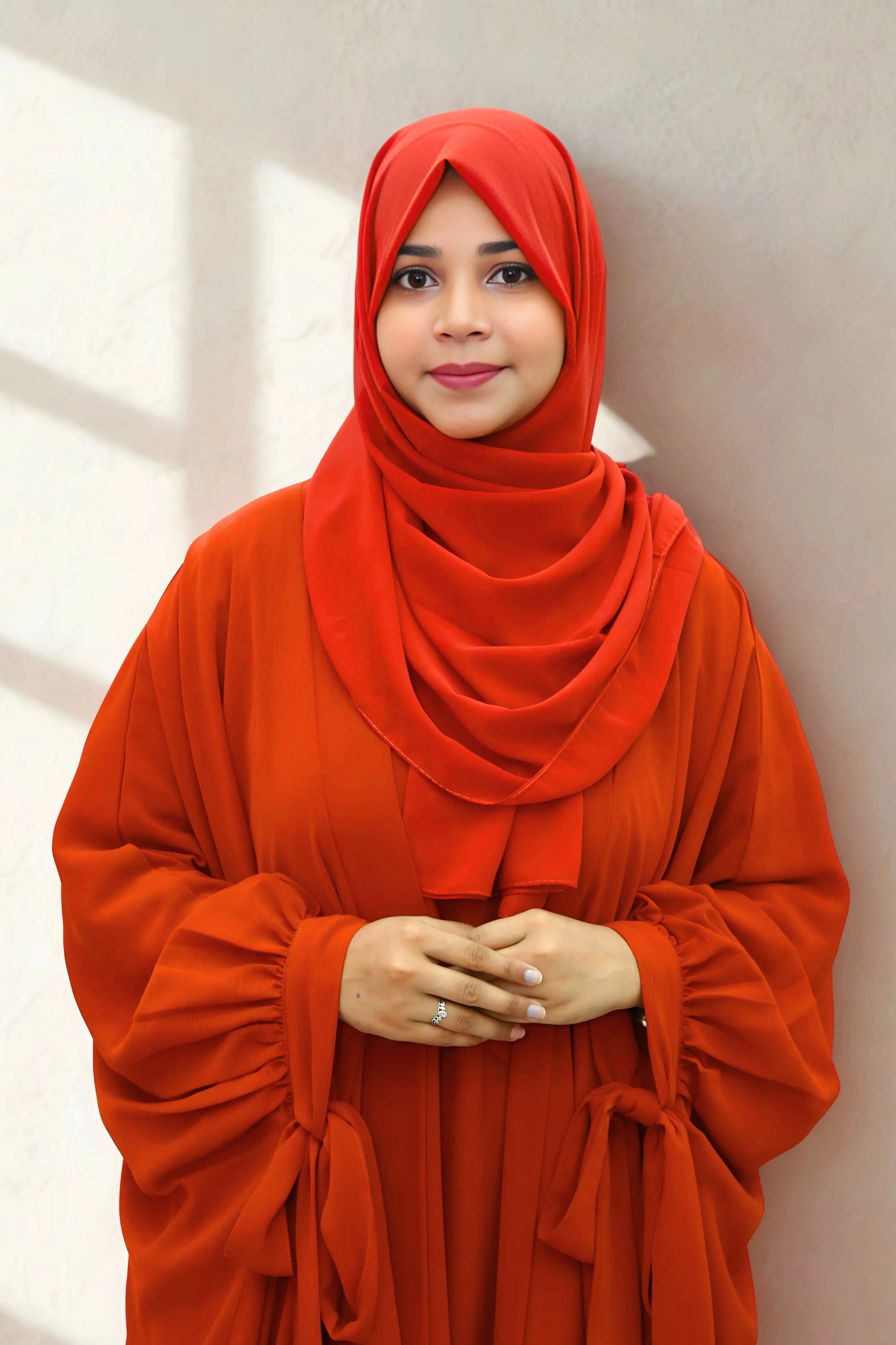 Girl in a modest abaya dress paired with a classic hijab for a timeless look.
