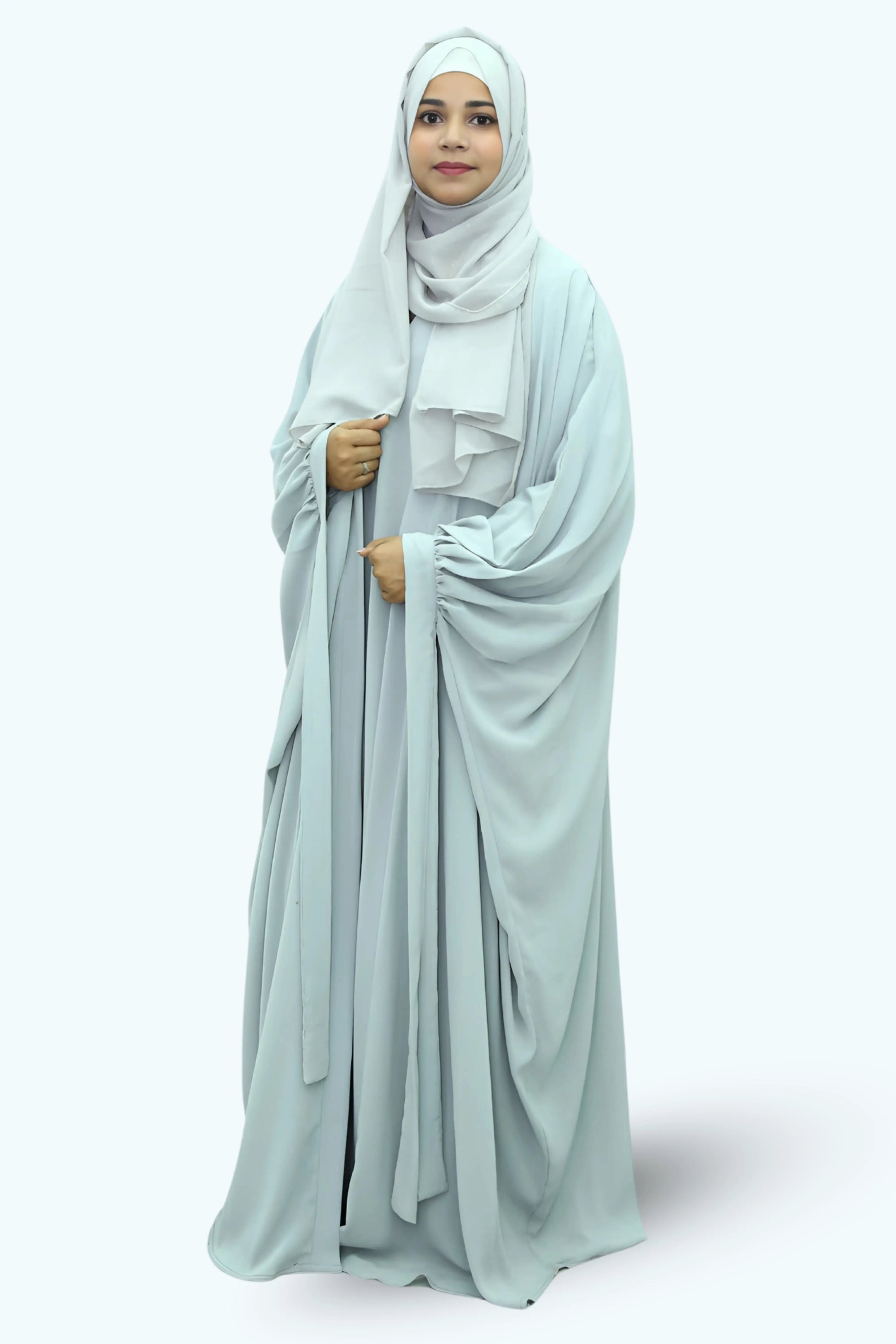 Modern Muslim girl in premium abaya and matching hijab standing with confidence.