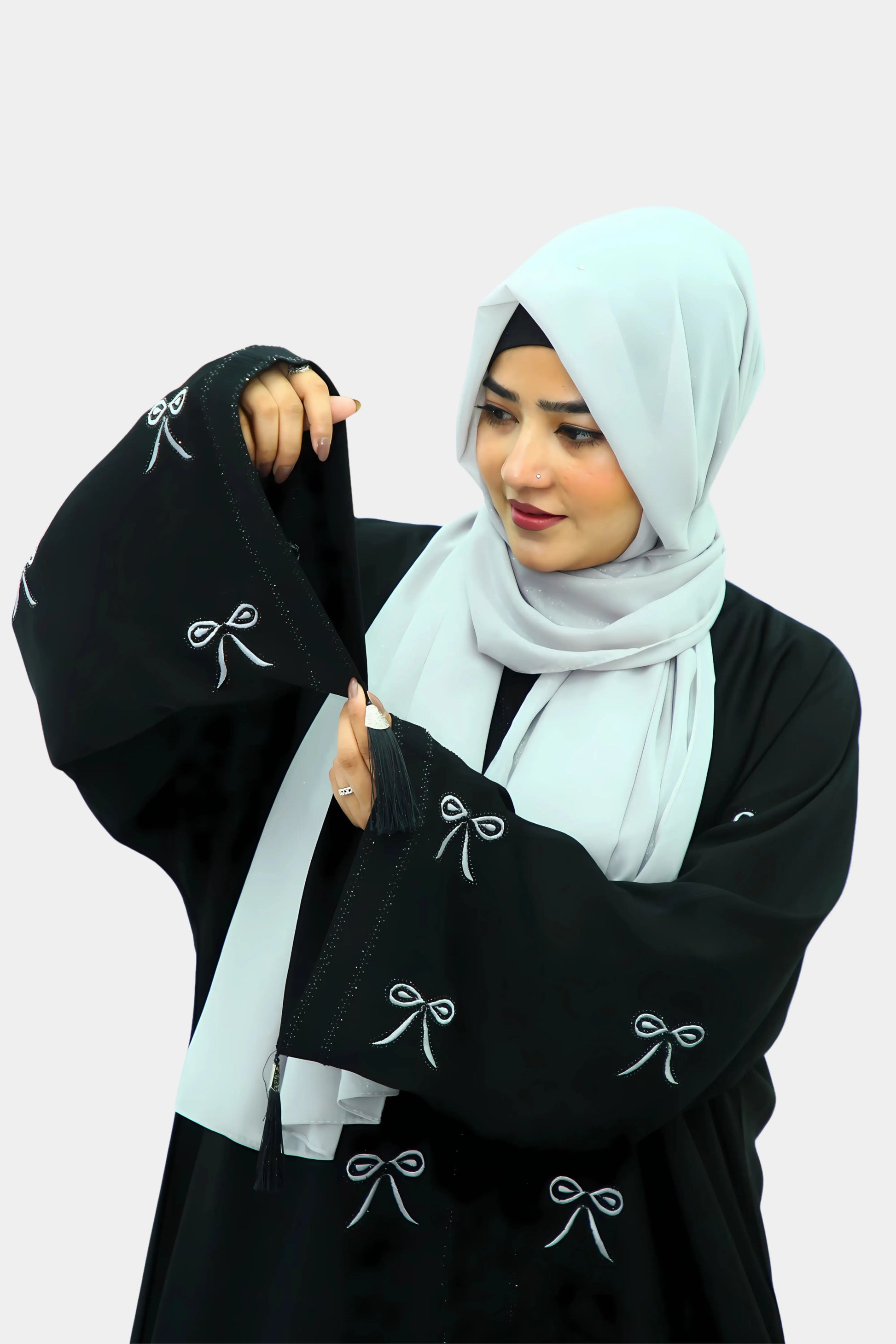 Muslim woman wearing a graceful abaya with a neatly draped hijab.