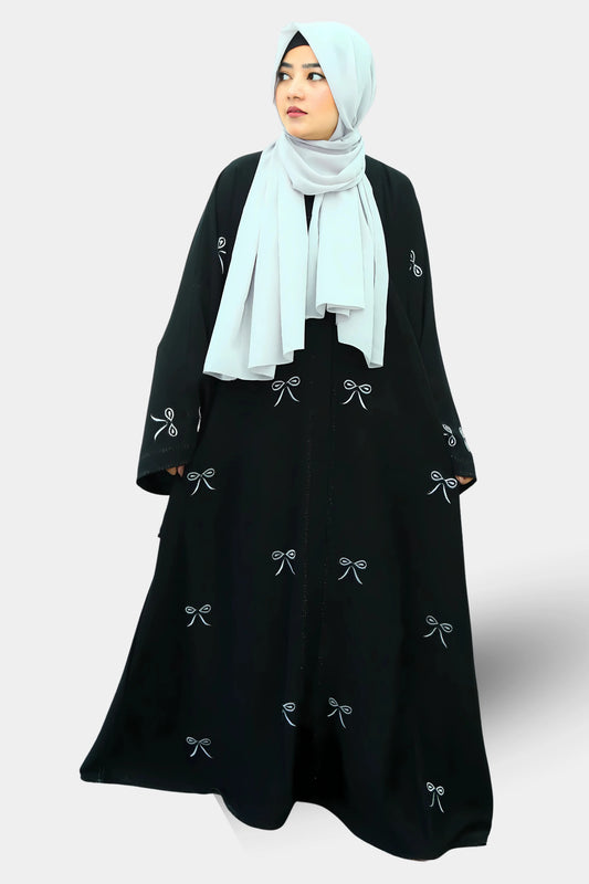 Muslim woman wearing a graceful abaya with a neatly draped hijab.