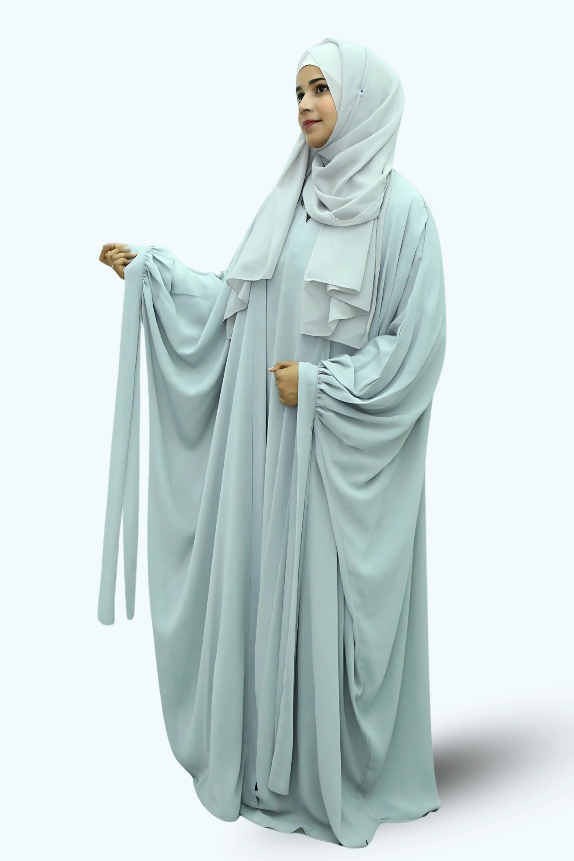 Modern Muslim girl in premium abaya and matching hijab standing with confidence.