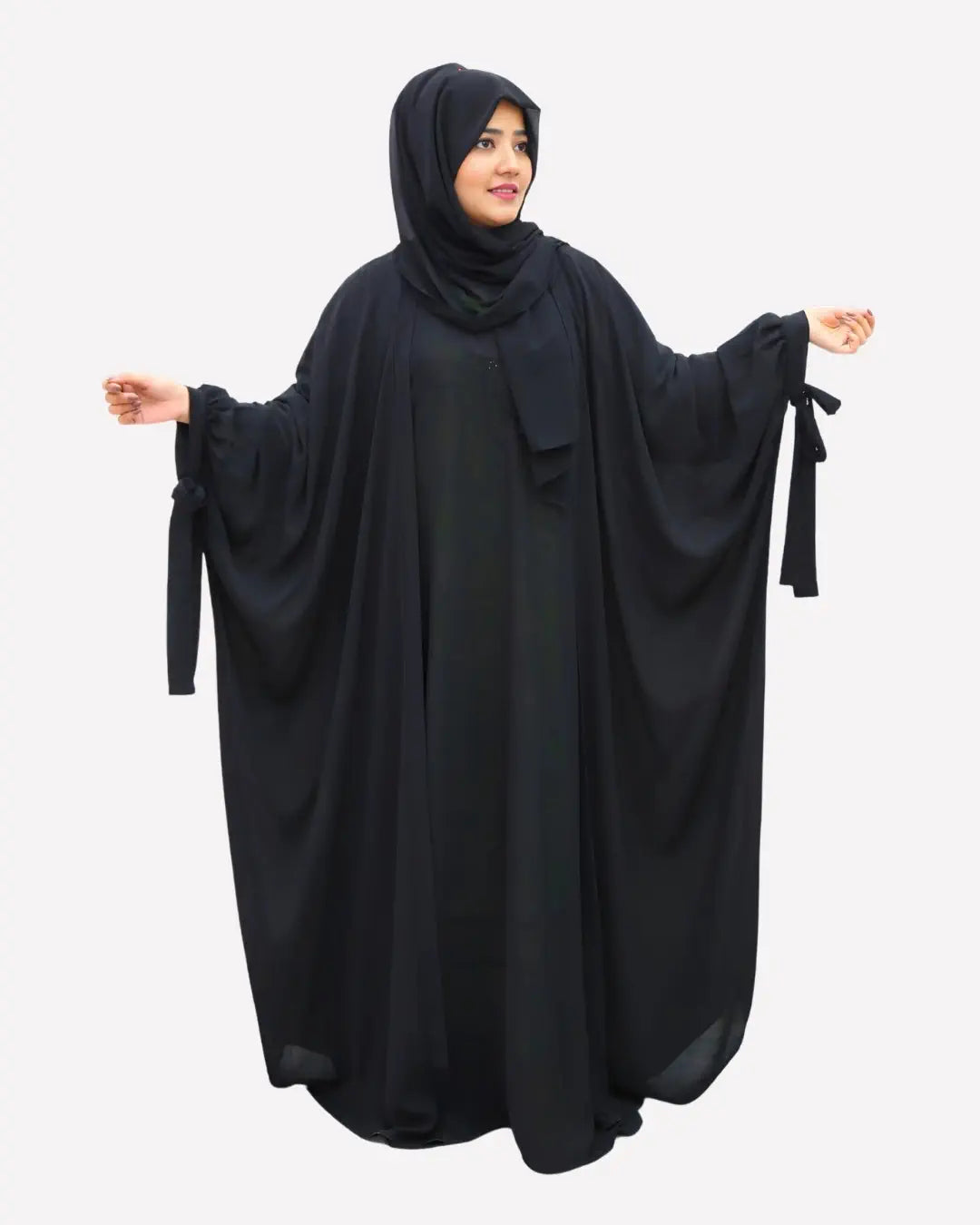 Woman wearing a black abaya on a white background
