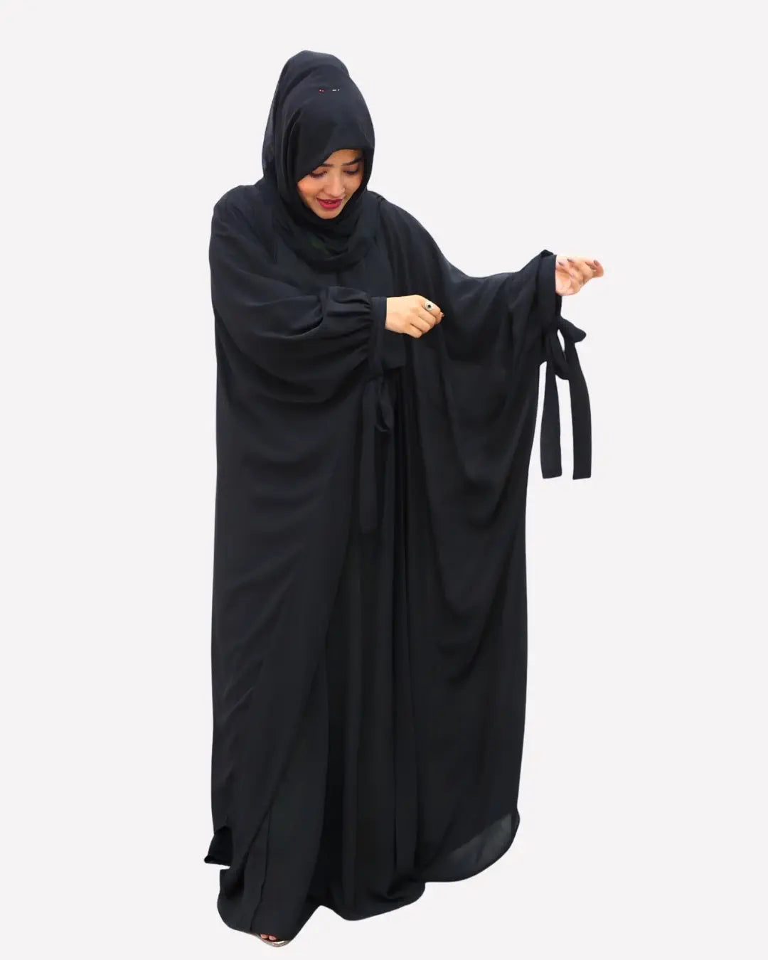 Woman wearing a black abaya on a white background
