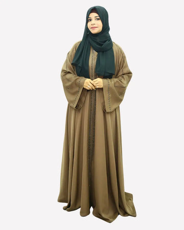Woman wearing an abaya dress with a green hijab on a white background