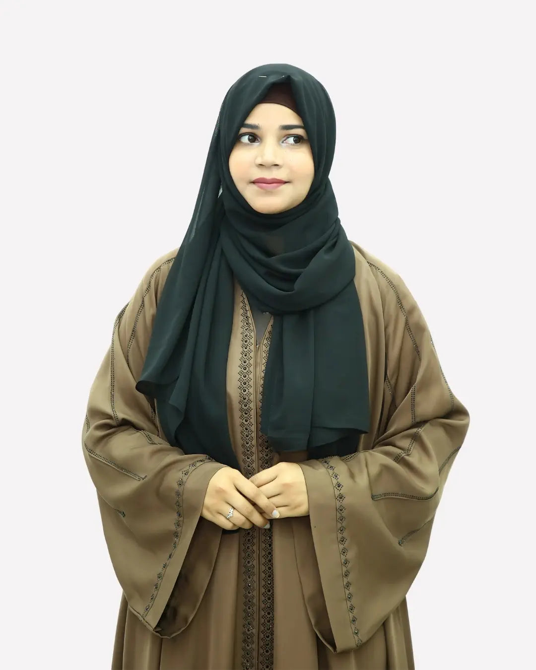 Woman wearing a black hijab and brown abaya on a white background