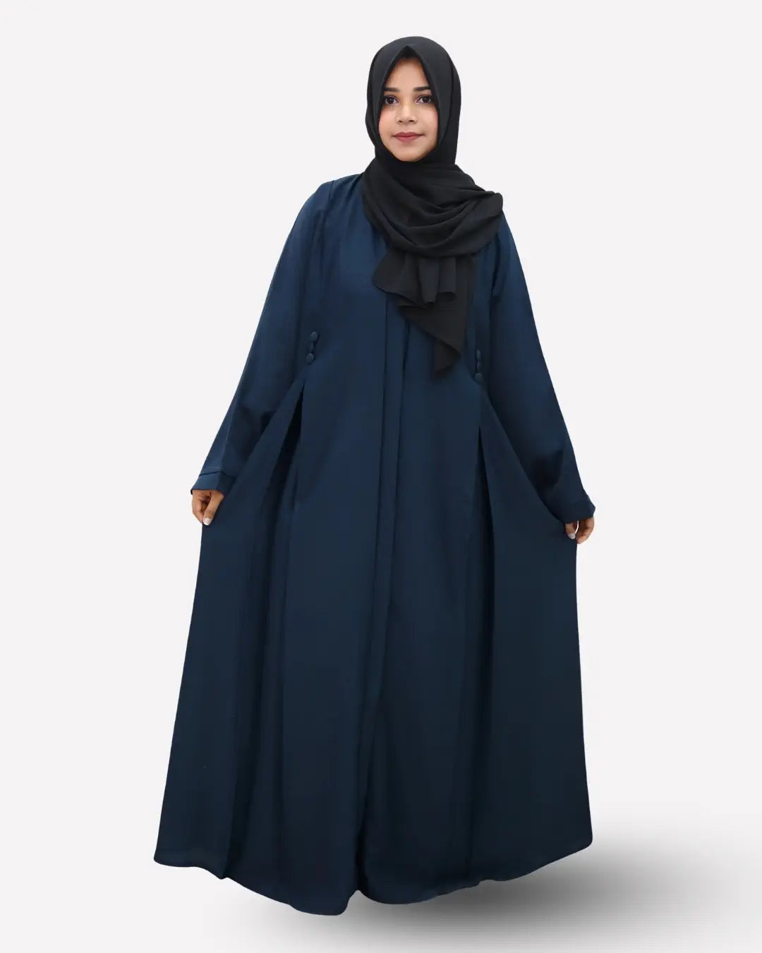 Woman wearing a navy blue abaya with a black hijab on a white background