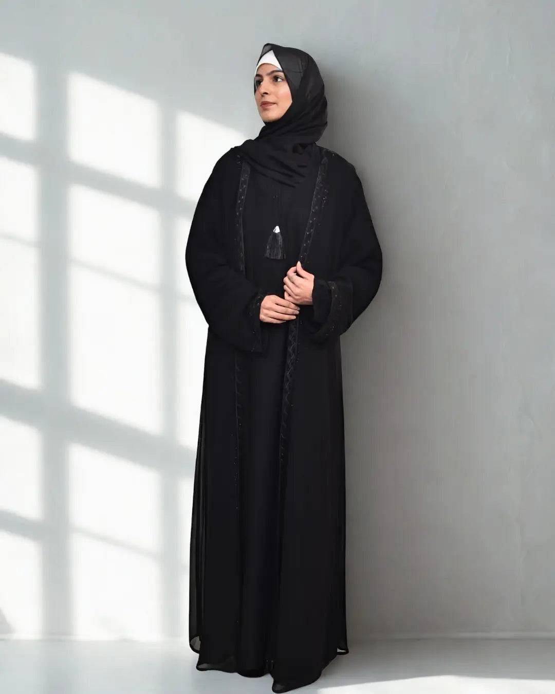 A girl wearing a premium quality abaya with black hijab