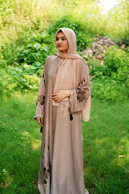 Girl in a modest abaya dress paired with a classic hijab for a timeless look.