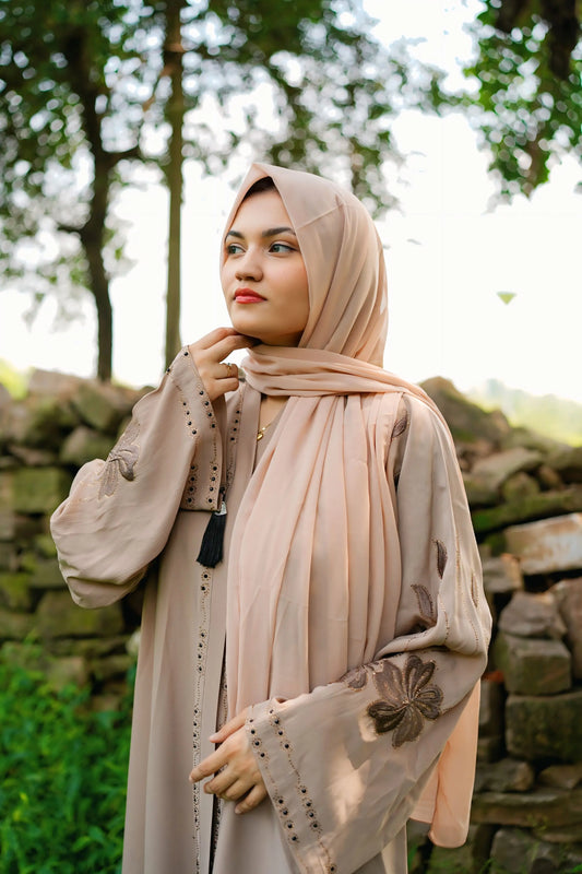 Girl in a modest abaya dress paired with a classic hijab for a timeless look.