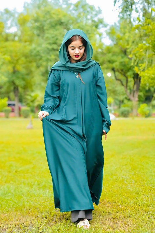 Elegant young woman wearing a abaya and hijab, showcasing modest fashion style.