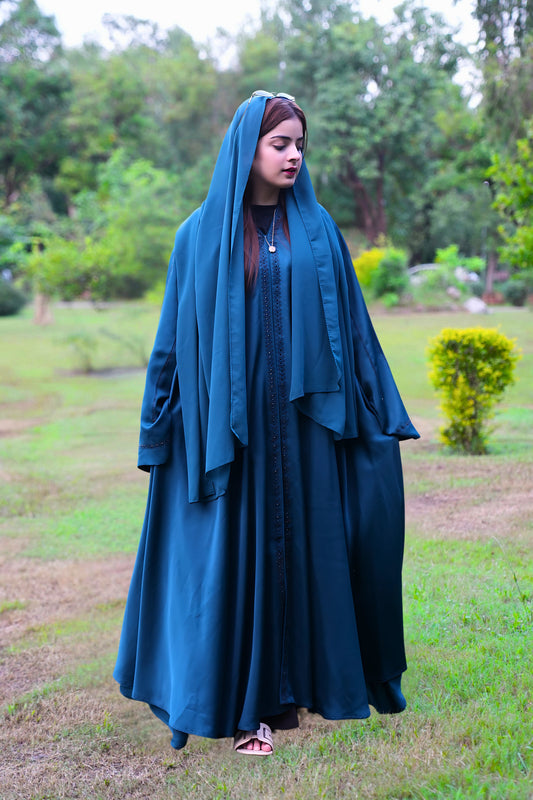 A girl wearing a premium quality abaya with hijab in a park
