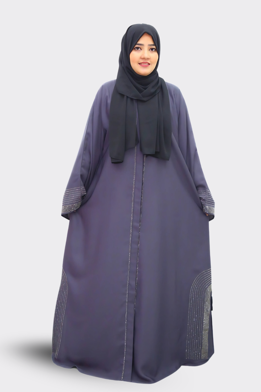 Woman wearing a long, dark purple abaya with a matching hijab on a white background