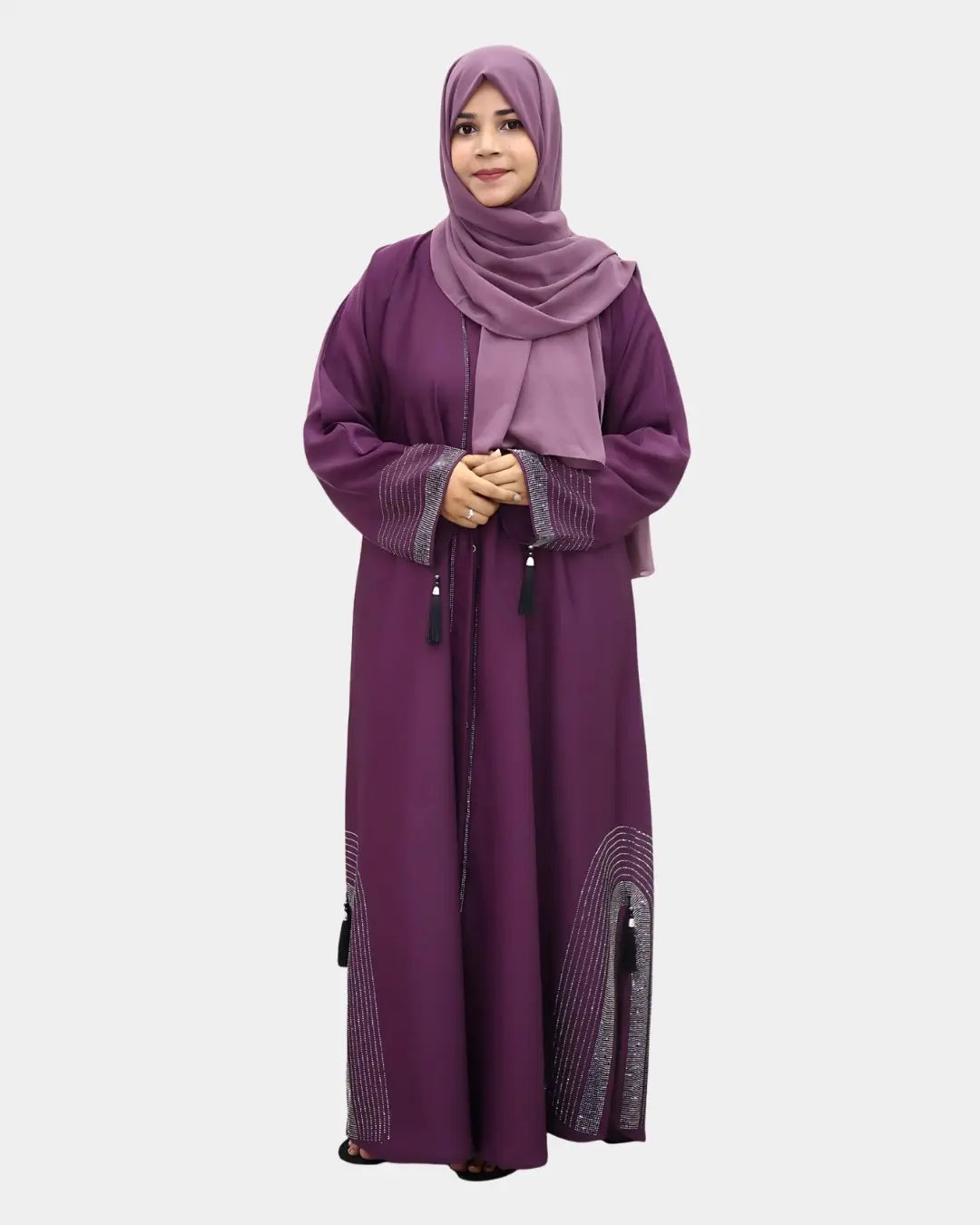 Woman wearing a long purple abaya with a matching hijab on a white background