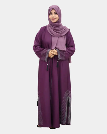 Woman wearing a long purple abaya with a matching hijab on a white background