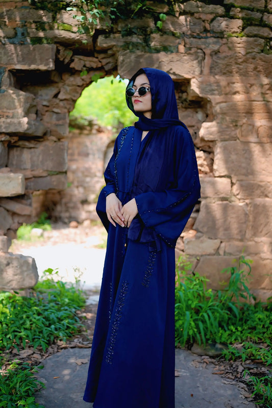 Muslim woman wearing a graceful abaya with a neatly draped hijab.