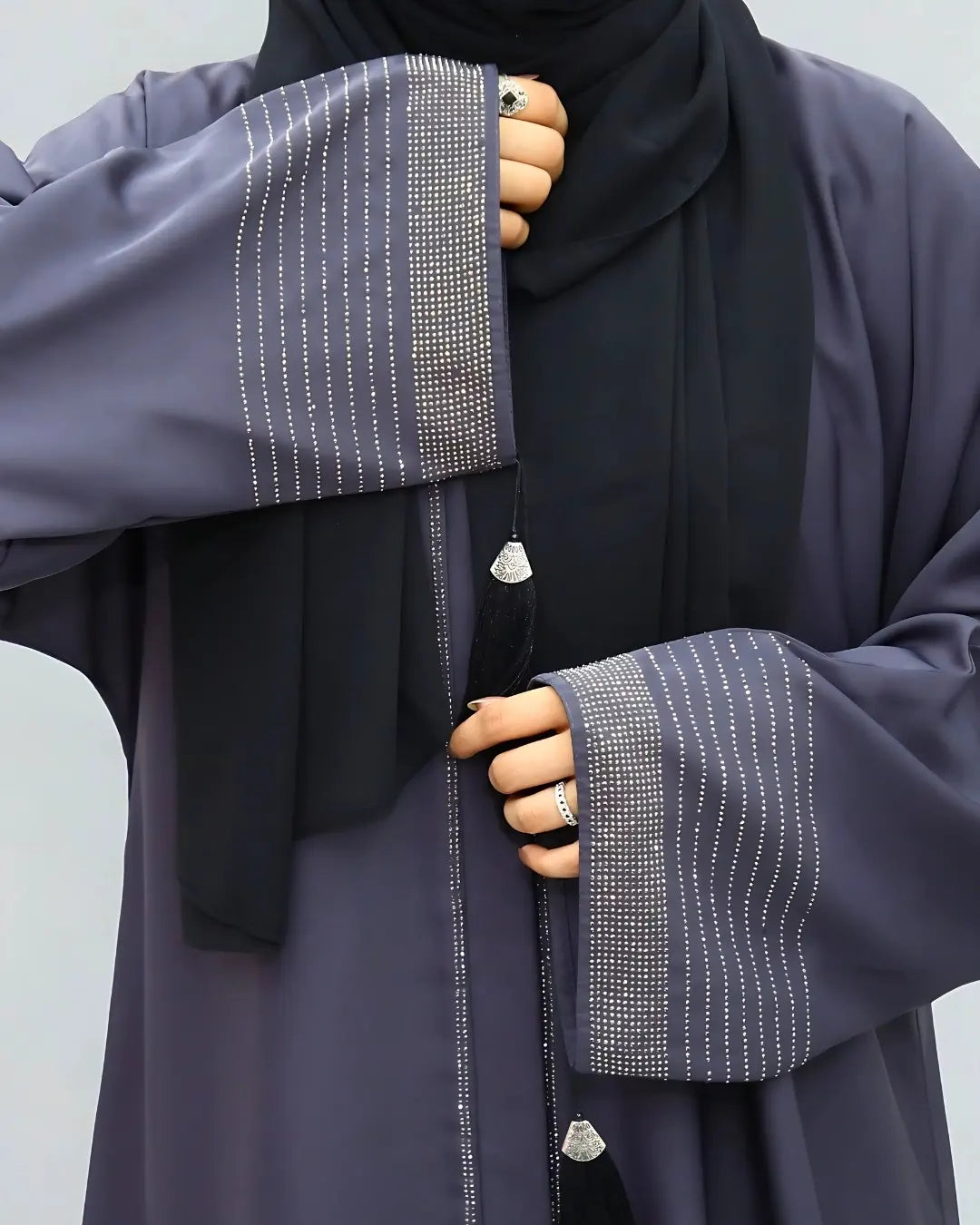 Navy blue abaya with decorative sleeves on a plain background