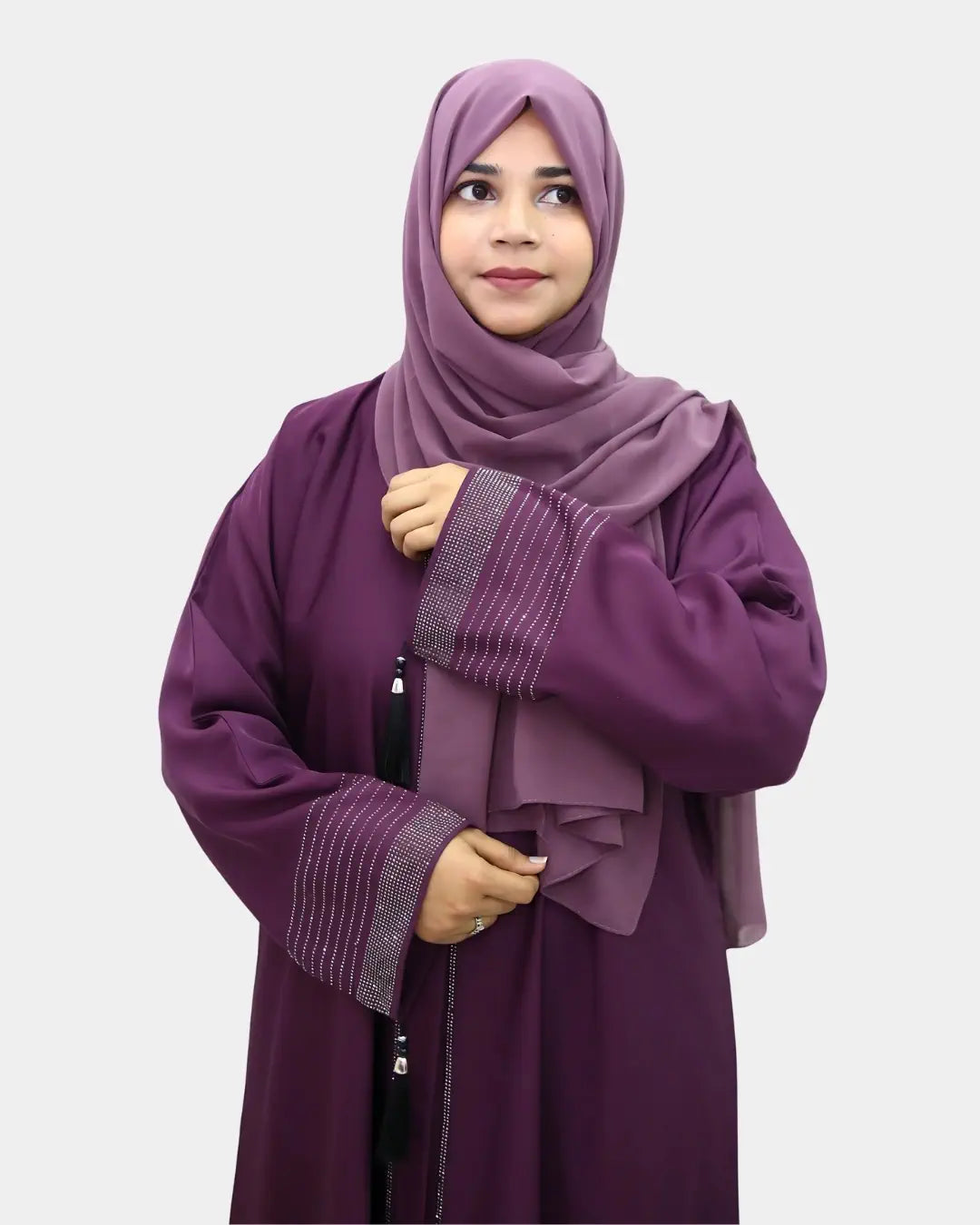 Woman wearing a purple abaya with matching hijab on a light gray background