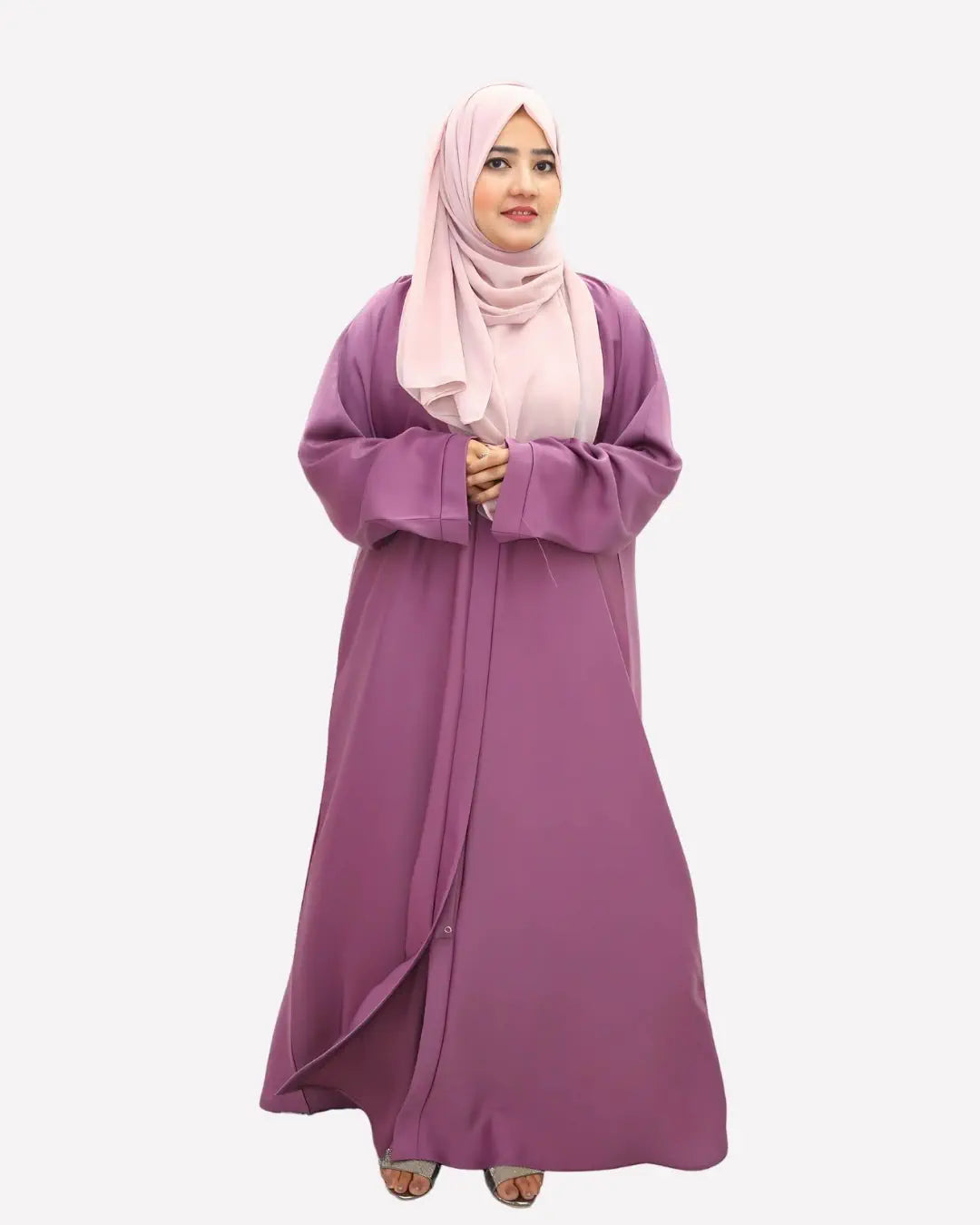 Woman wearing a long purple abaya and pink hijab on a white background