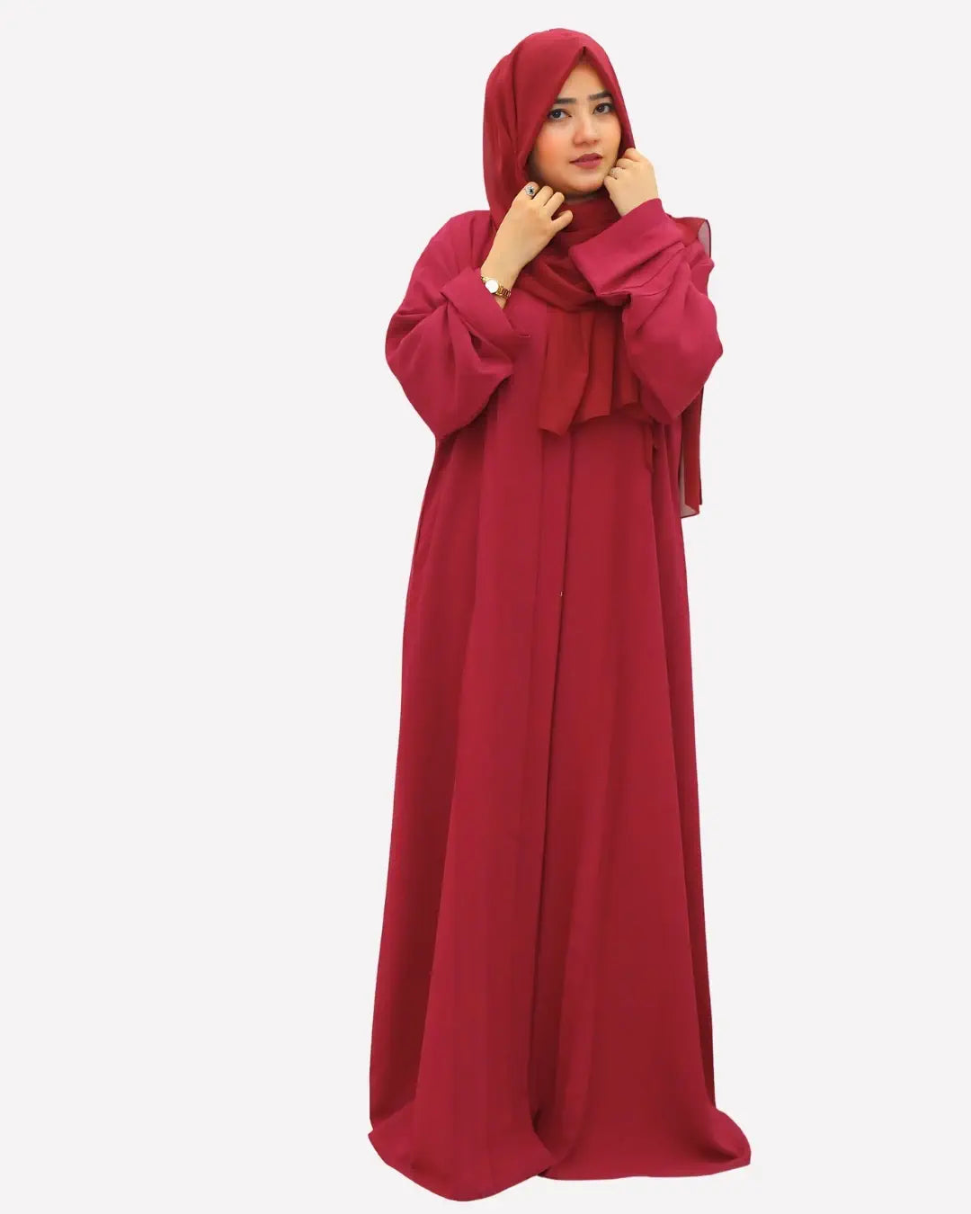 Red abaya worn by a model on a white background