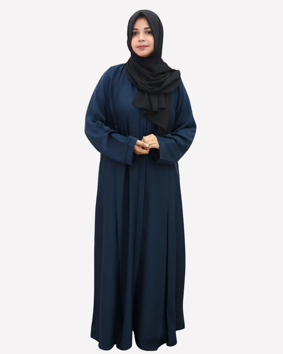 Woman wearing a long dark blue abaya with a black hijab on a white background
