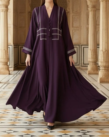 purple abaya with white embroidery in a decorative interior setting