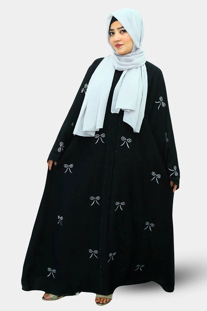 Muslim woman wearing a graceful abaya with a neatly draped hijab.