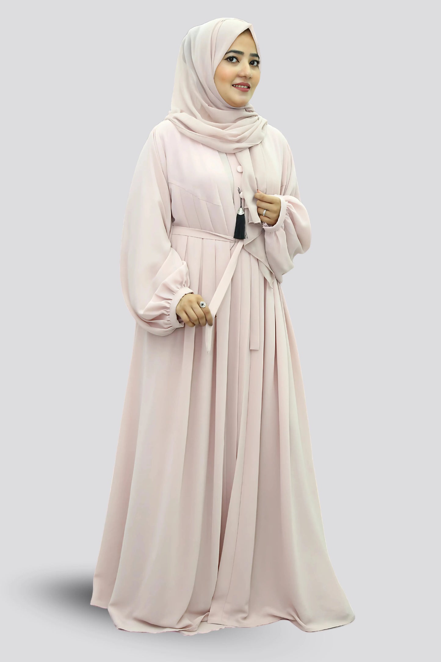 Elegant young woman wearing a black abaya and hijab, showcasing modest fashion style.