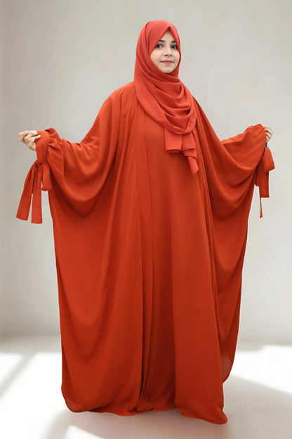 Girl in a modest abaya dress paired with a classic hijab for a timeless look.